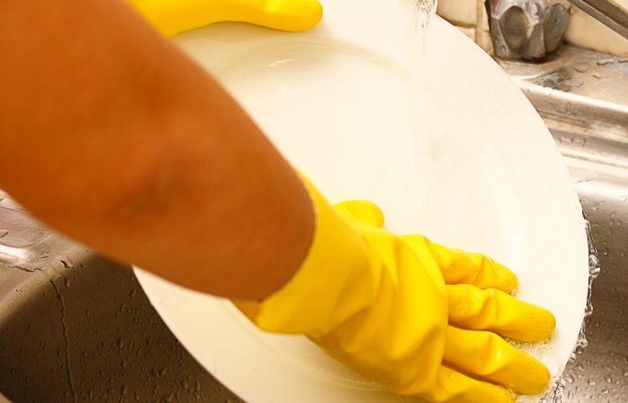 Washing Plates As Part Of The Daily Chores