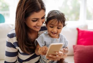 Mom Laughing at Phone with Daughter