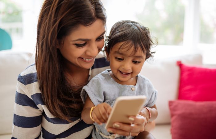Mom Laughing at Phone with Daughter