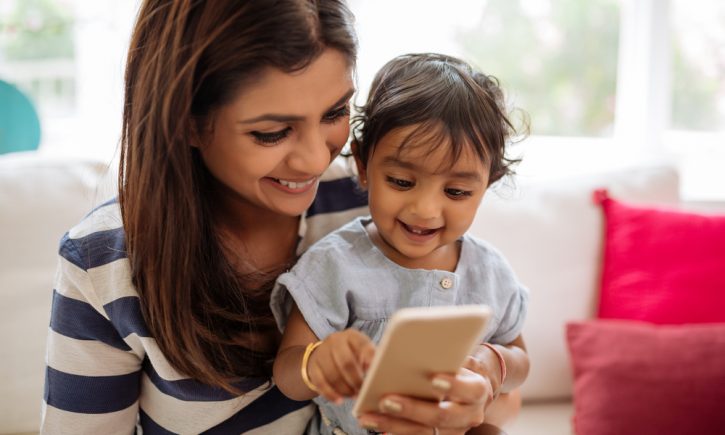 Mom Laughing at Phone with Daughter